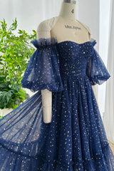 Midnight blue off-shoulder evening dress with gold star mesh fabric ruched bodice and romantic puff sleeves displayed on mannequin Miss Jophiel studio