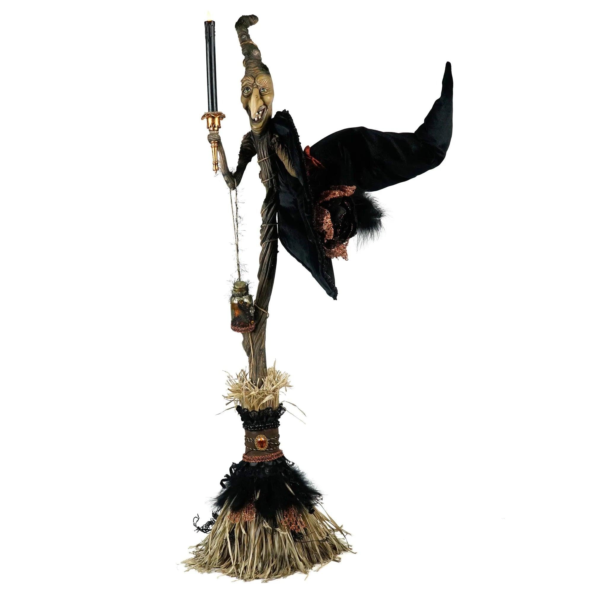 Katherine's Collection witch broom with hand-painted face, black velvet hat, potion bottle, and candlestick.