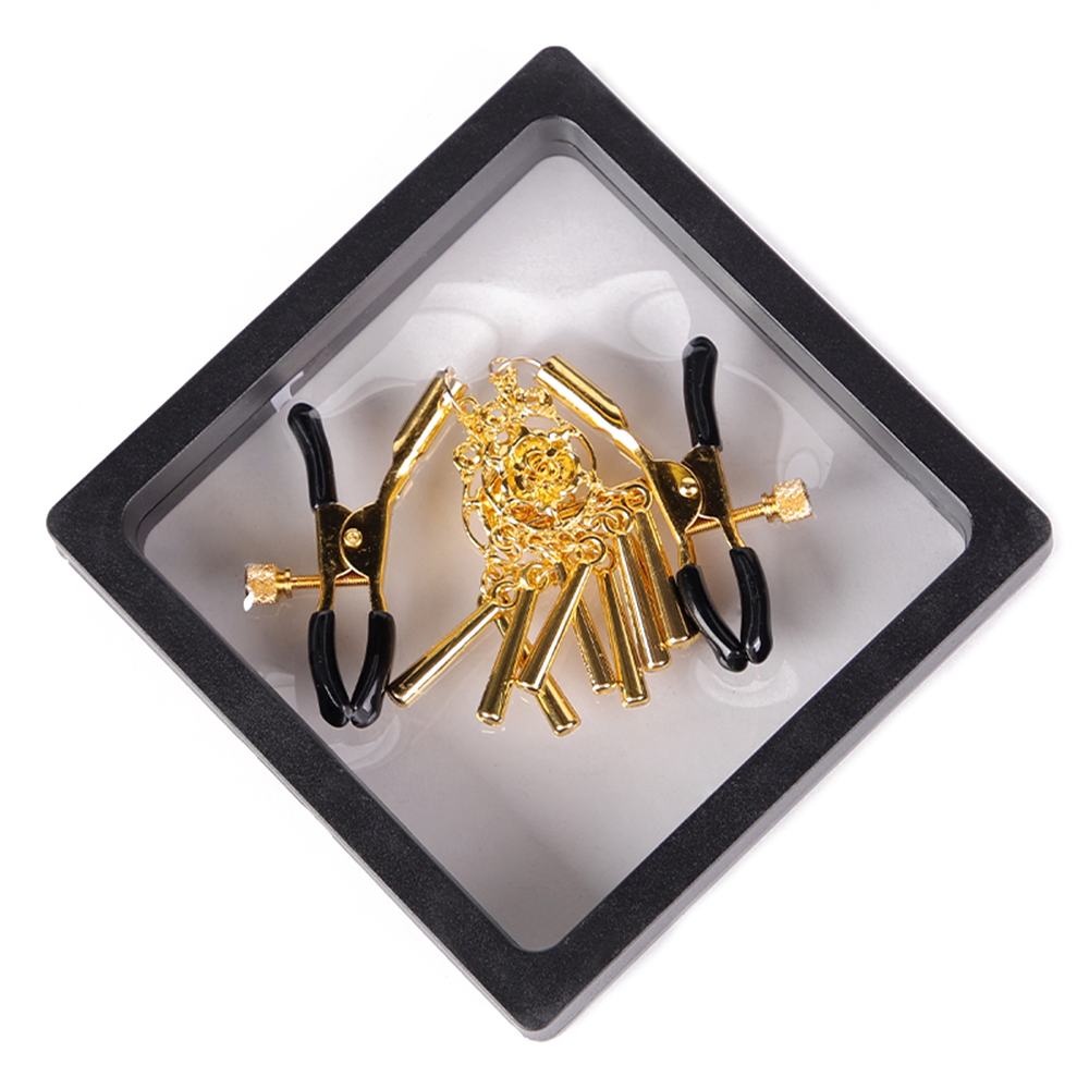 A pair of gold rose chime tassel nipple clamps sits in its clear package.